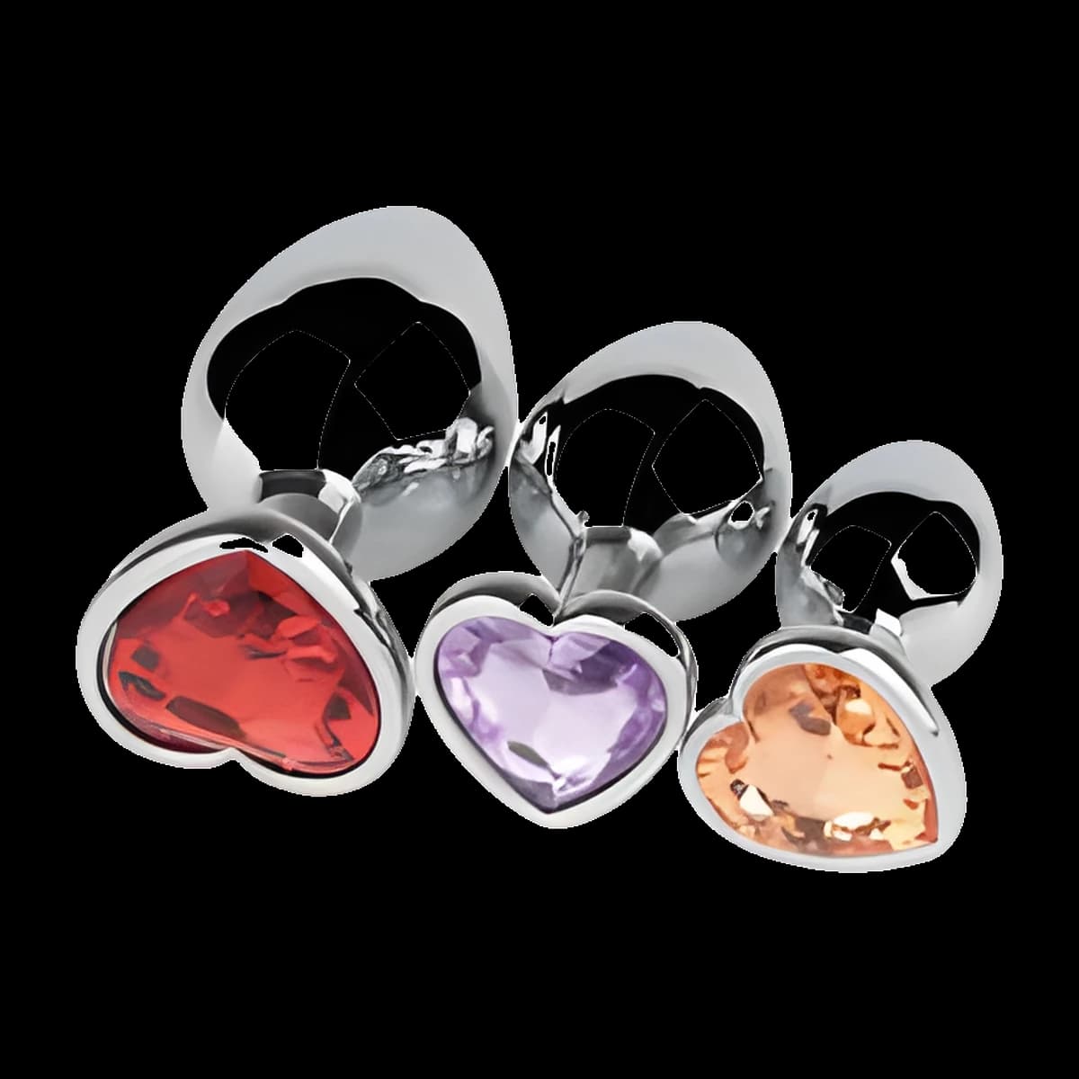 Three polished silver plugs in graduated sizes lying side by side, with heart shaped jewels in red, lilac and amber at their bases.