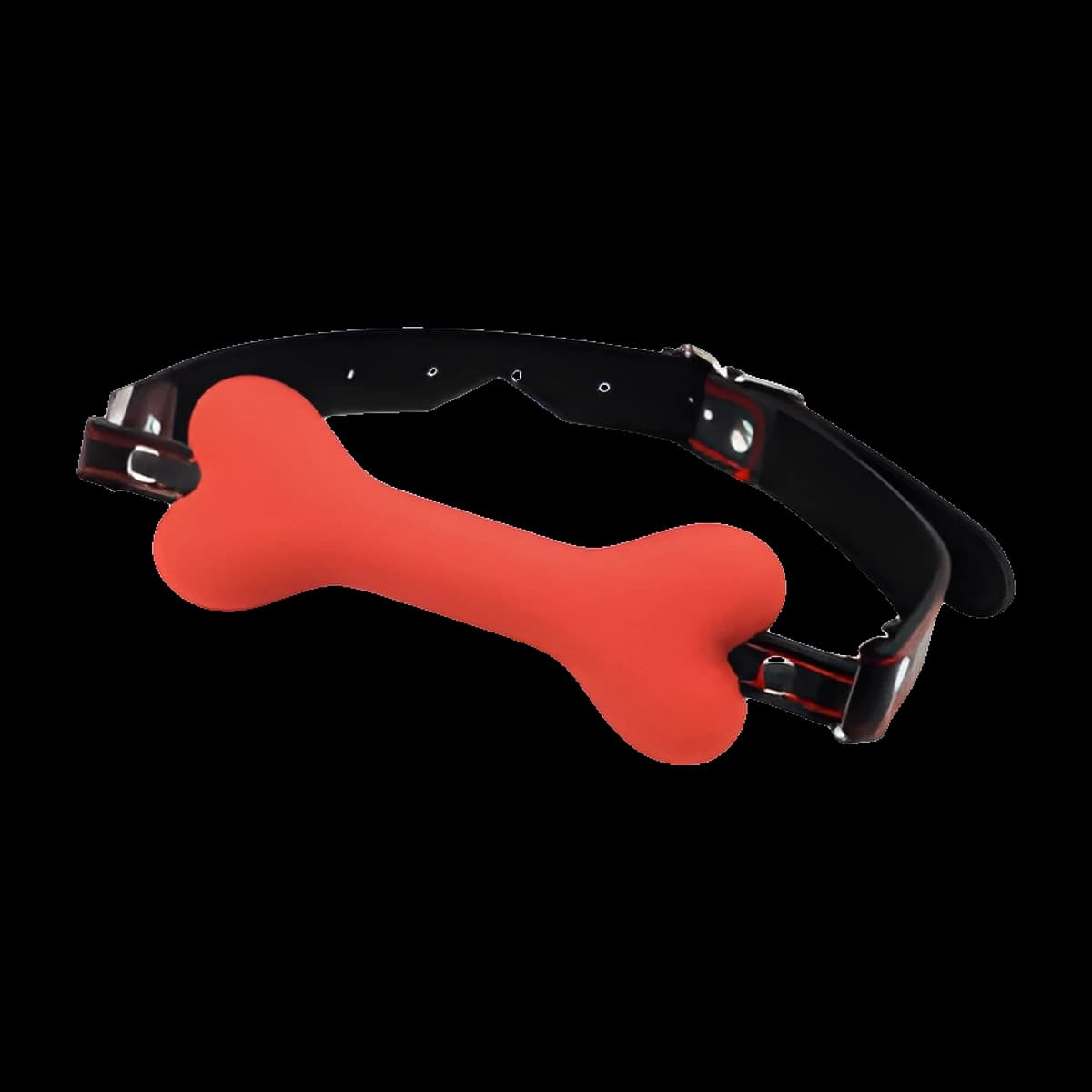 A red bone shaped mouthpiece fixed to a black strap with metal buckles and red edging, resting on a white block.